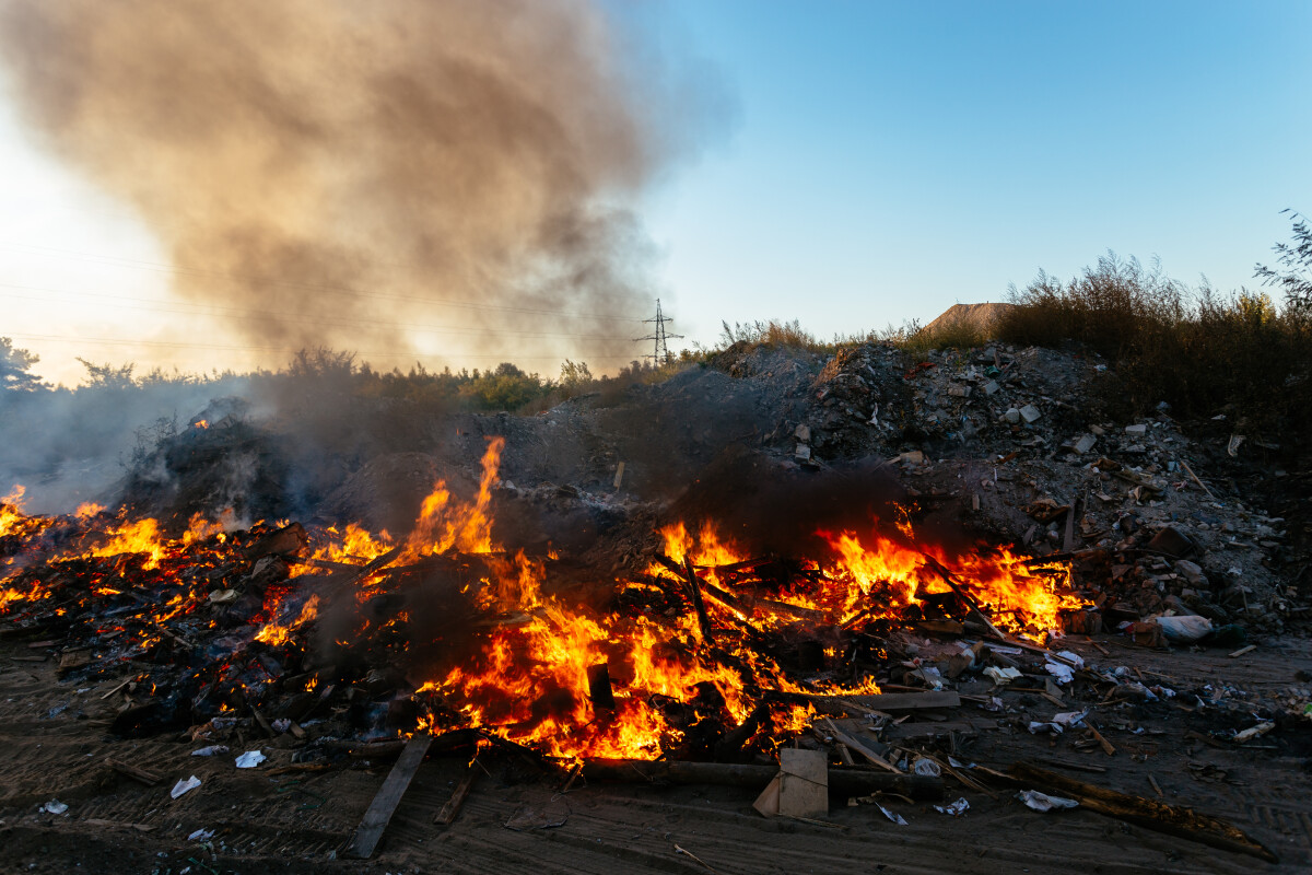 Burning garbage at landfill. Air pollution concept