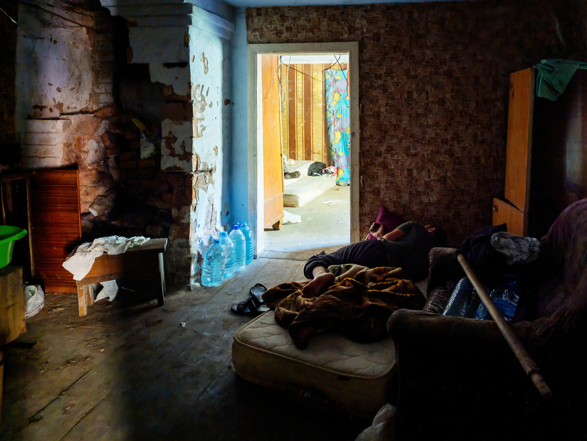 Homeless people sleeping in abandoned house