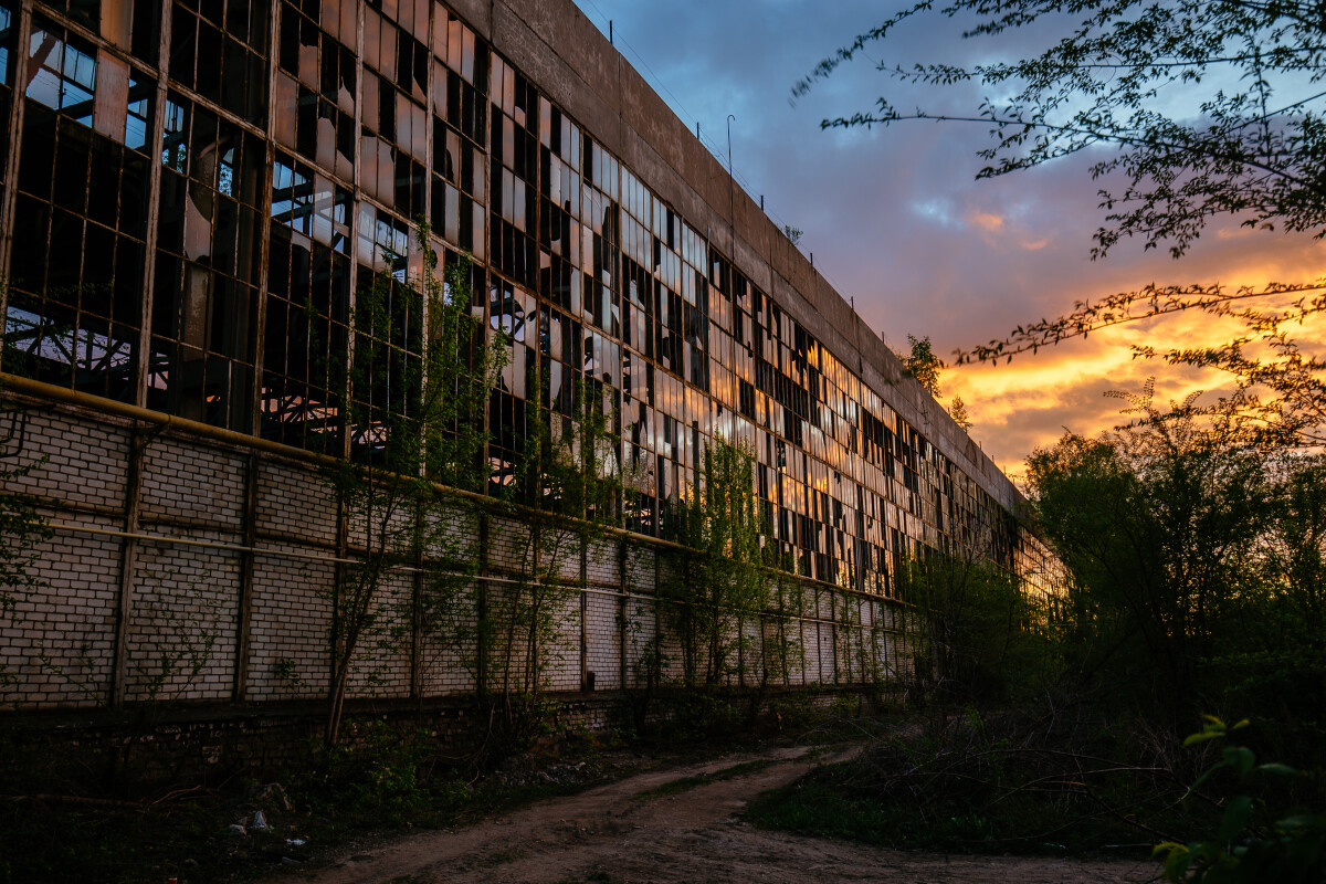 Old abandoned industrial building at sunset