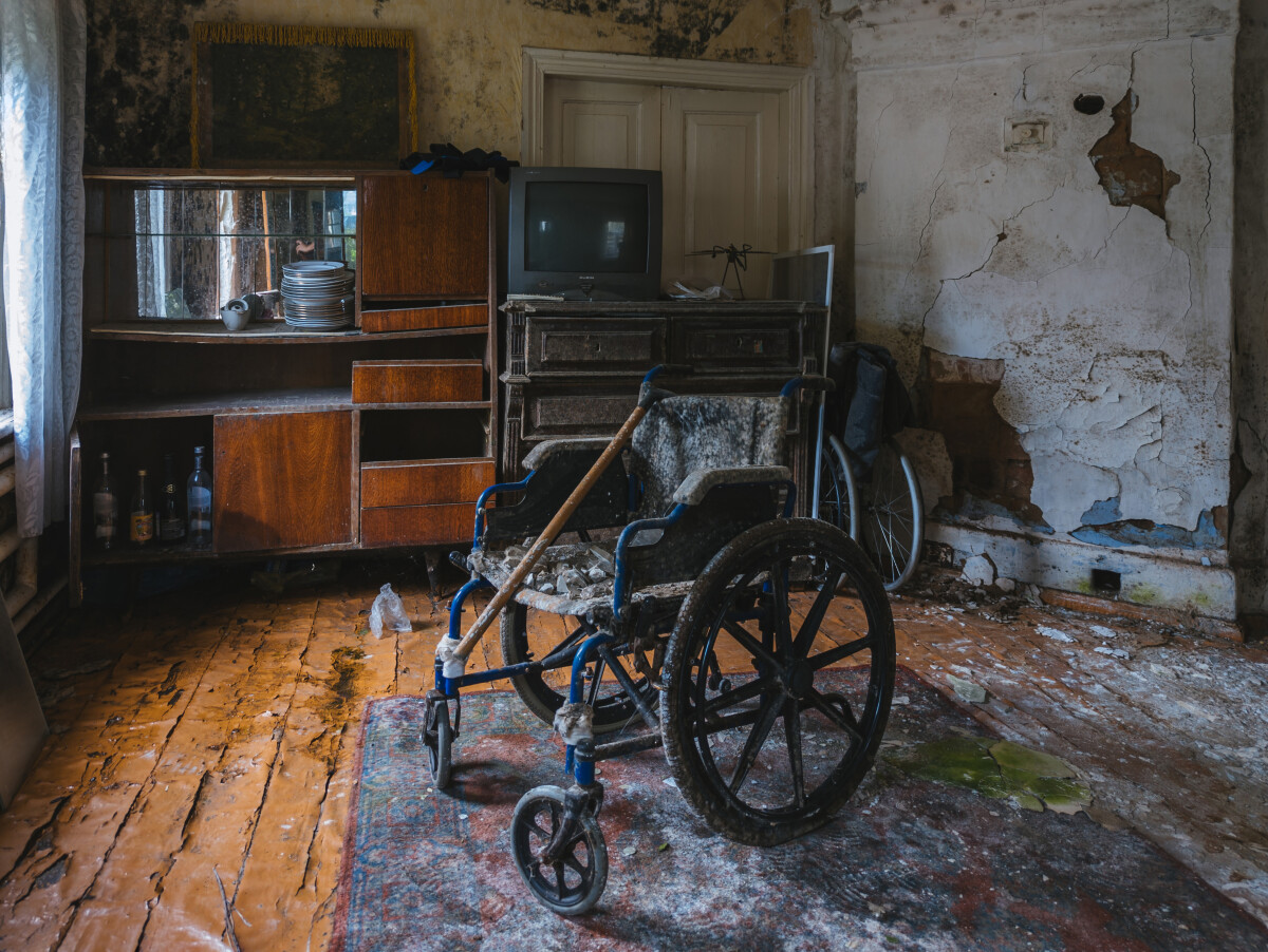 Empty wheelchair in old abandoned house