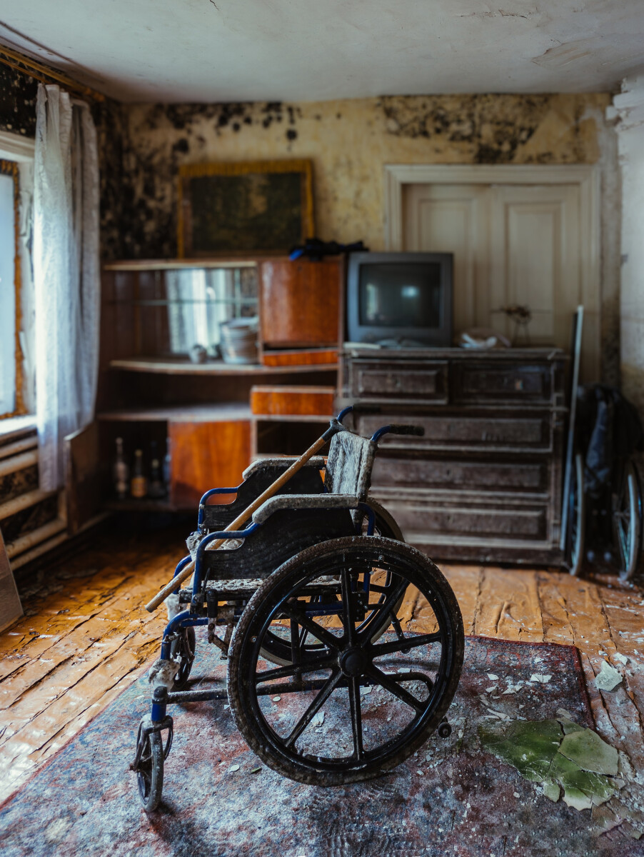 Empty wheelchair in old abandoned house