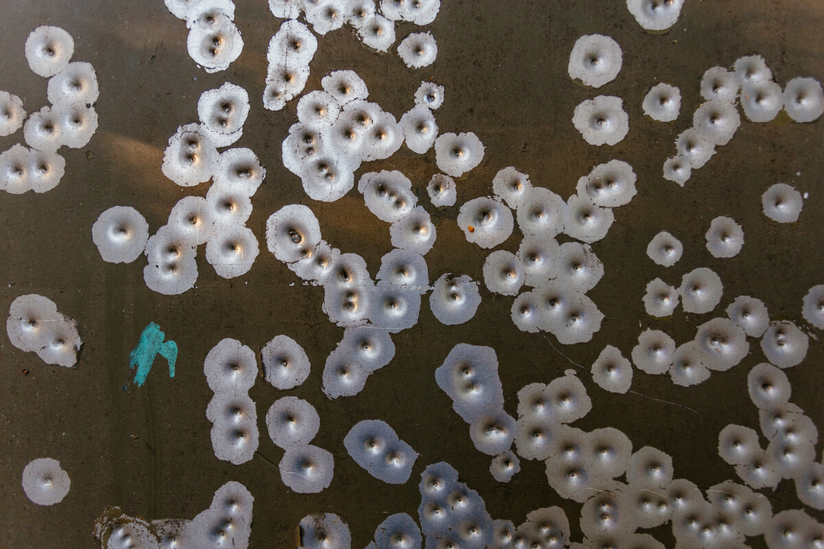 Marks of bullets on military vehicle body