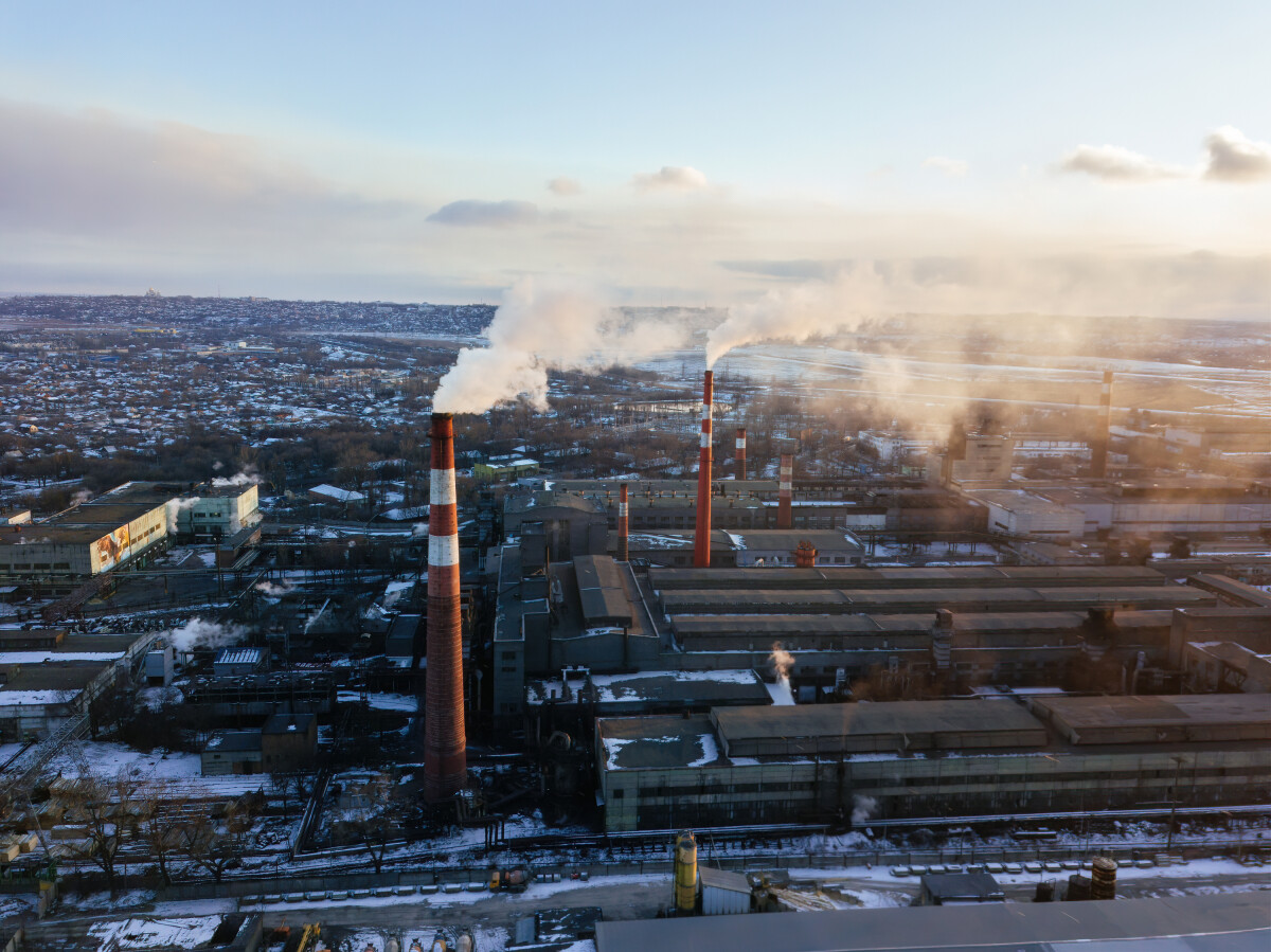 Industrial landscape at the sunset, aerial view. Smoke coming out from factory chimneys