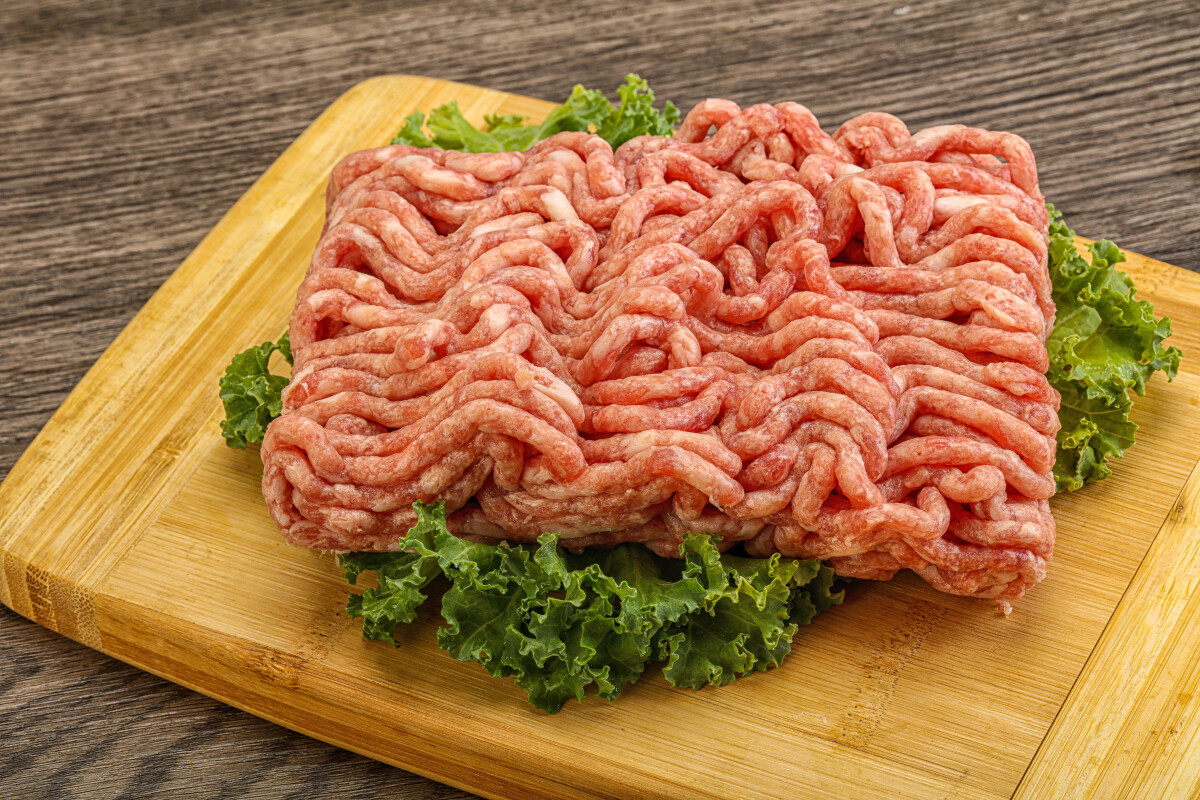 Raw pork minced meat over board