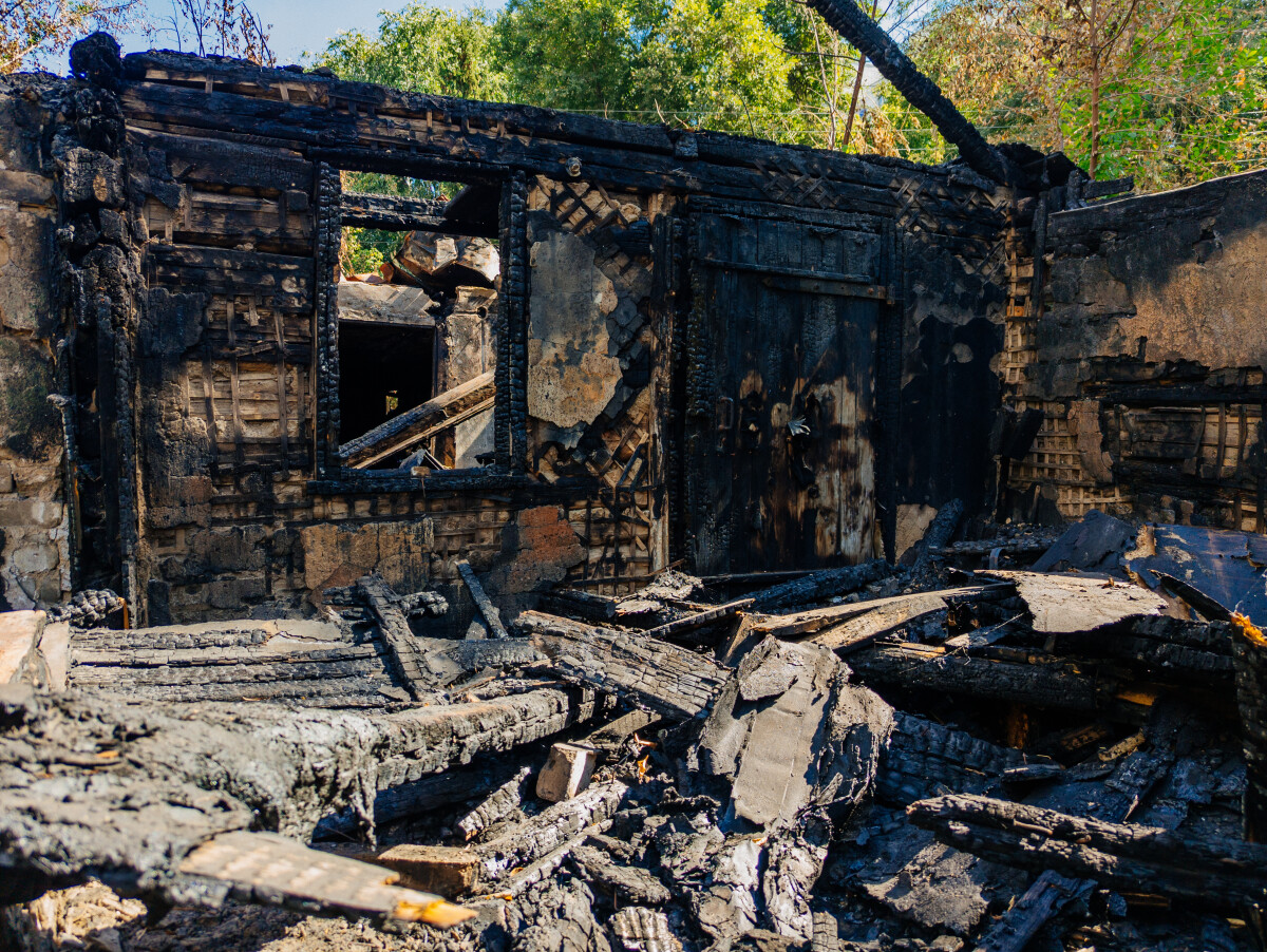 Consequences of fire. Completely burnt wooden house