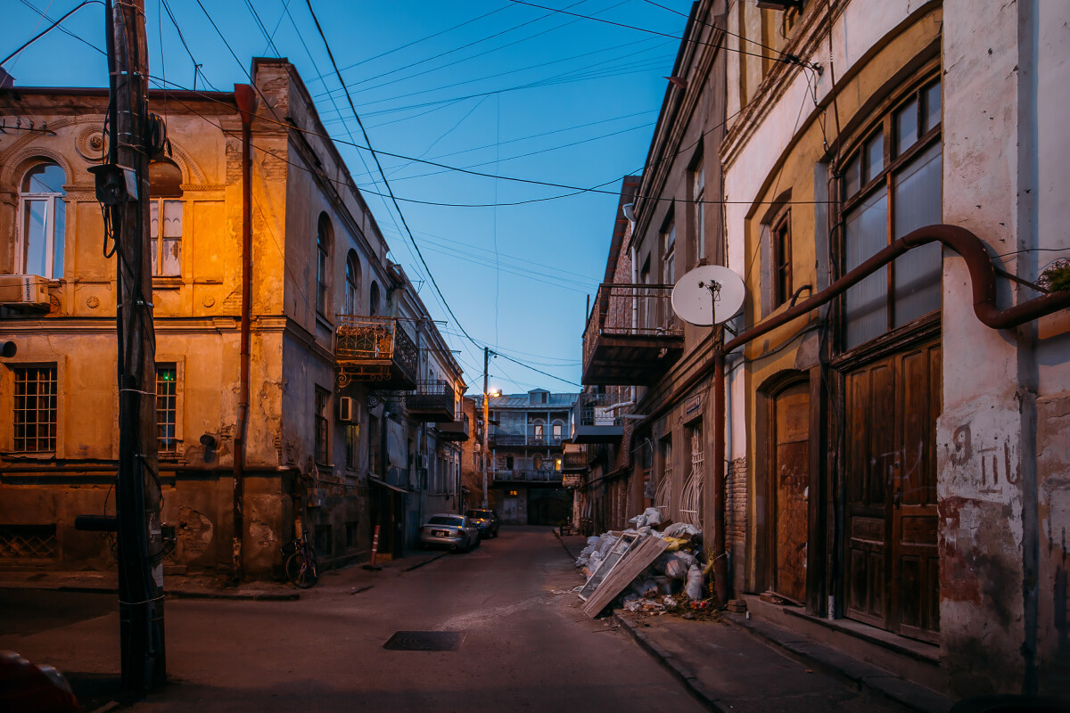 Old shabby houses in the slum district at Tbilisi at night