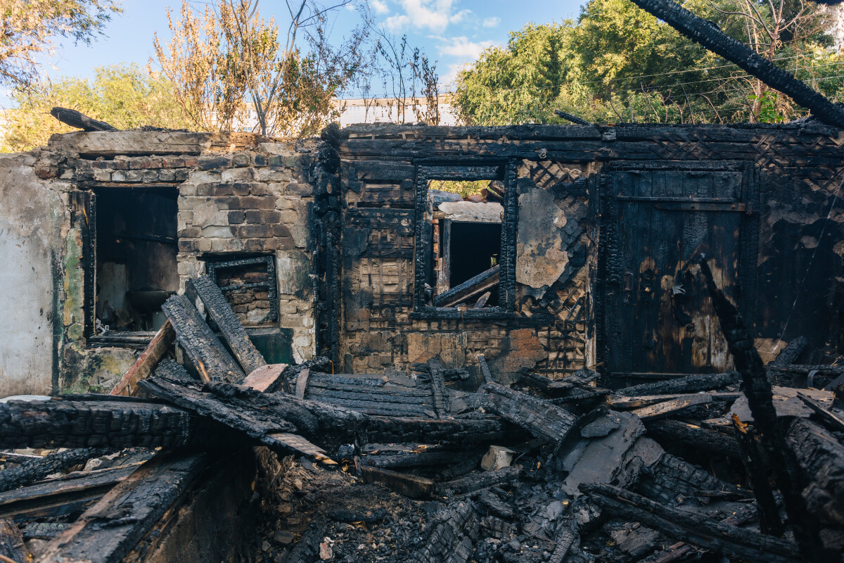 Consequences of fire. Completely burnt wooden house