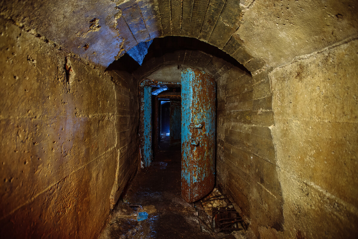 Rusted metal armored door in old abandoned Soviet bunker