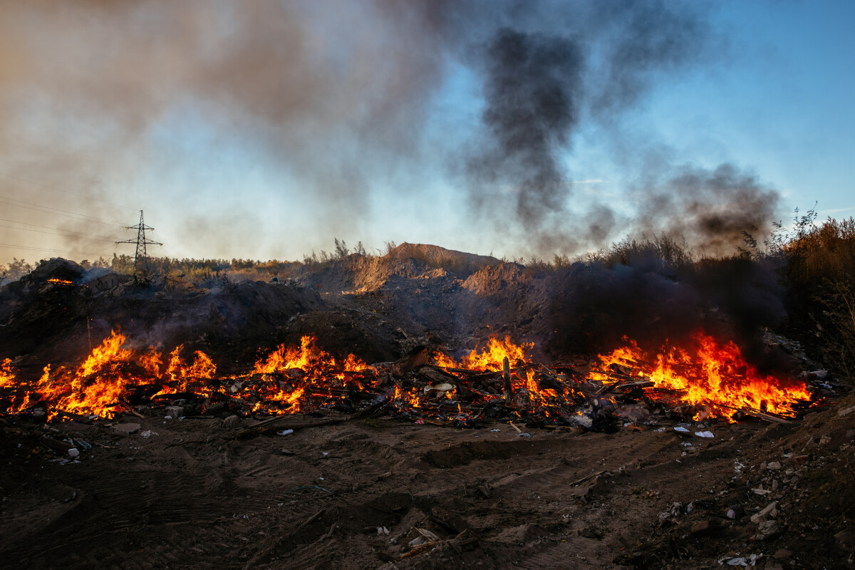 Burning garbage at landfill. Air pollution concept