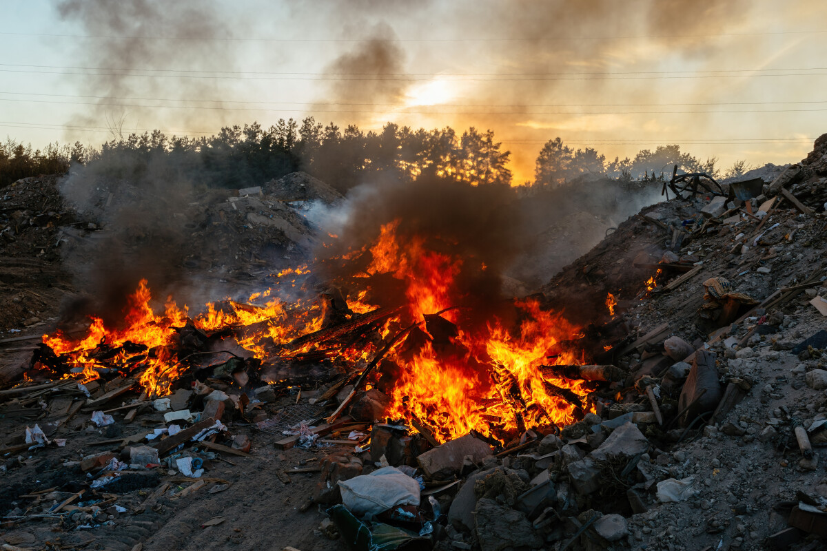 Burning garbage at landfill. Air pollution concept