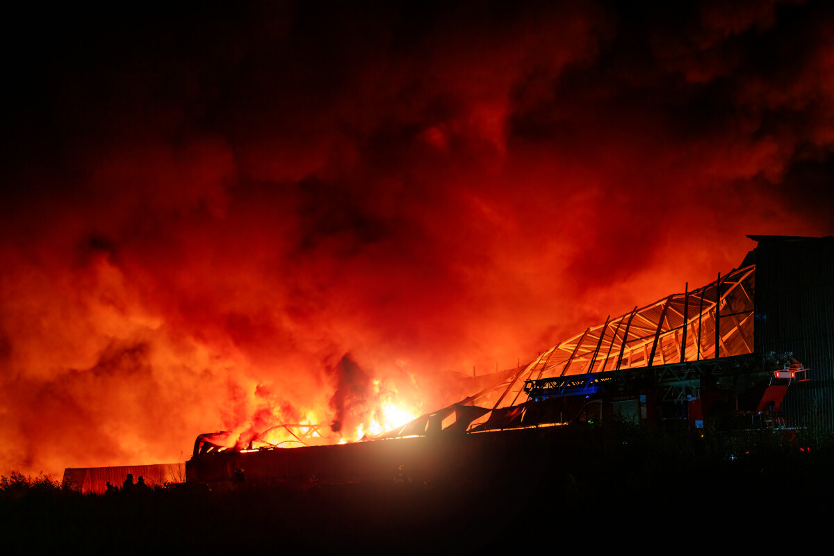 Burning industrial building. Big blaze at night