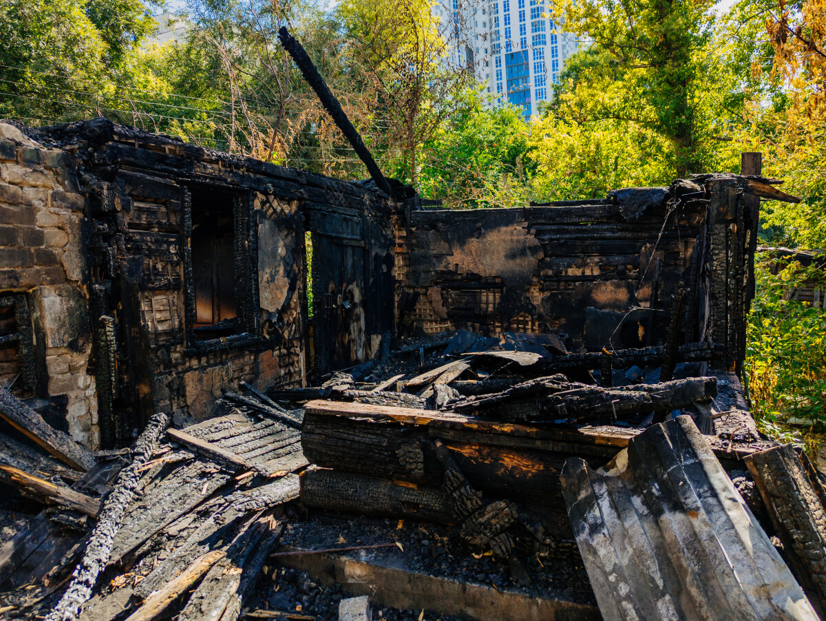 Consequences of fire. Completely burnt wooden house