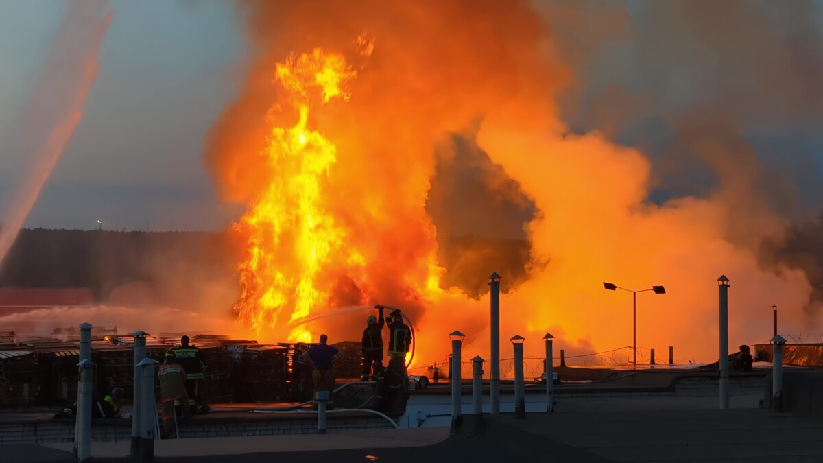 Firefighters extinguish burning industrial building in the city