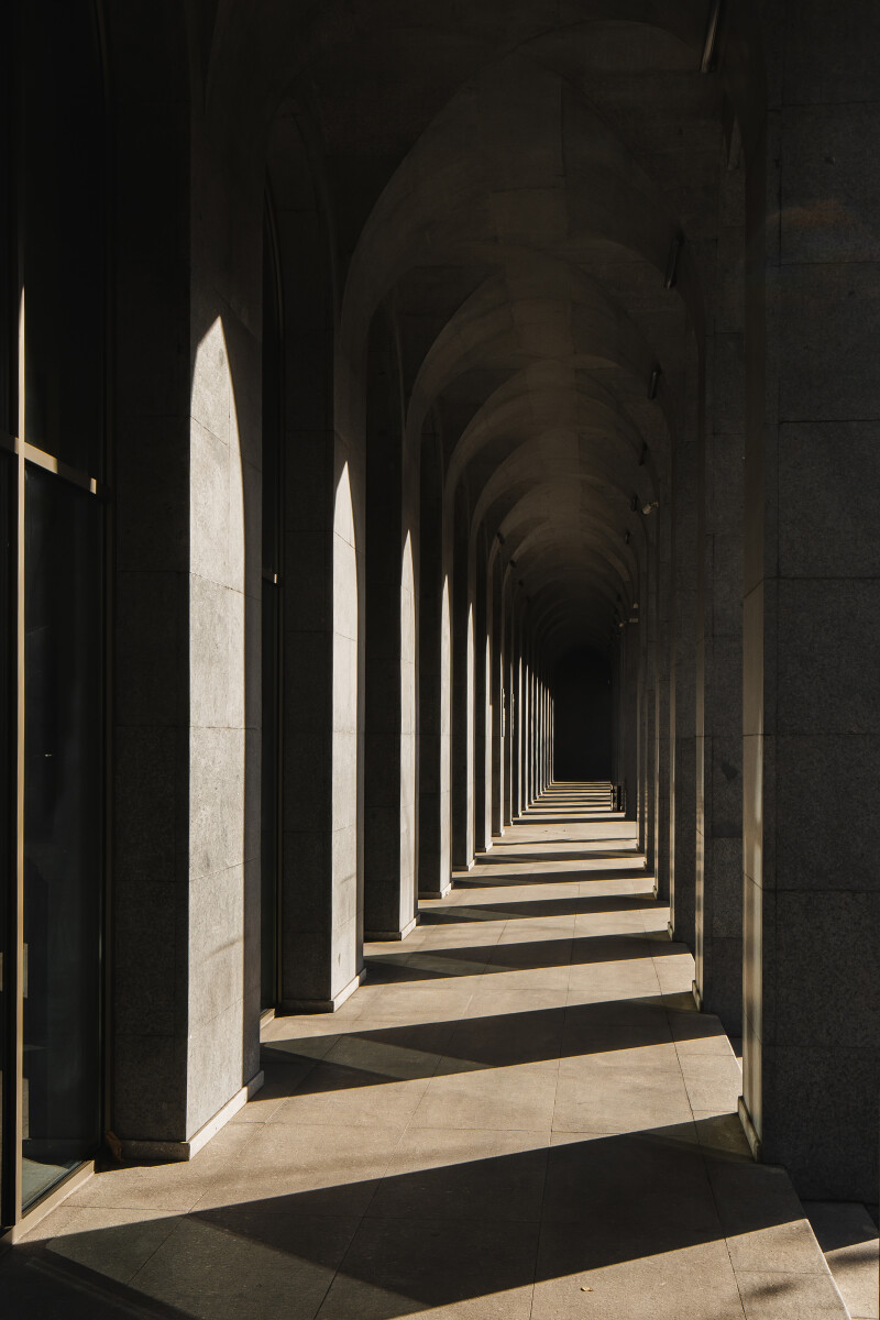 Corridor with rows of columns in sunlight