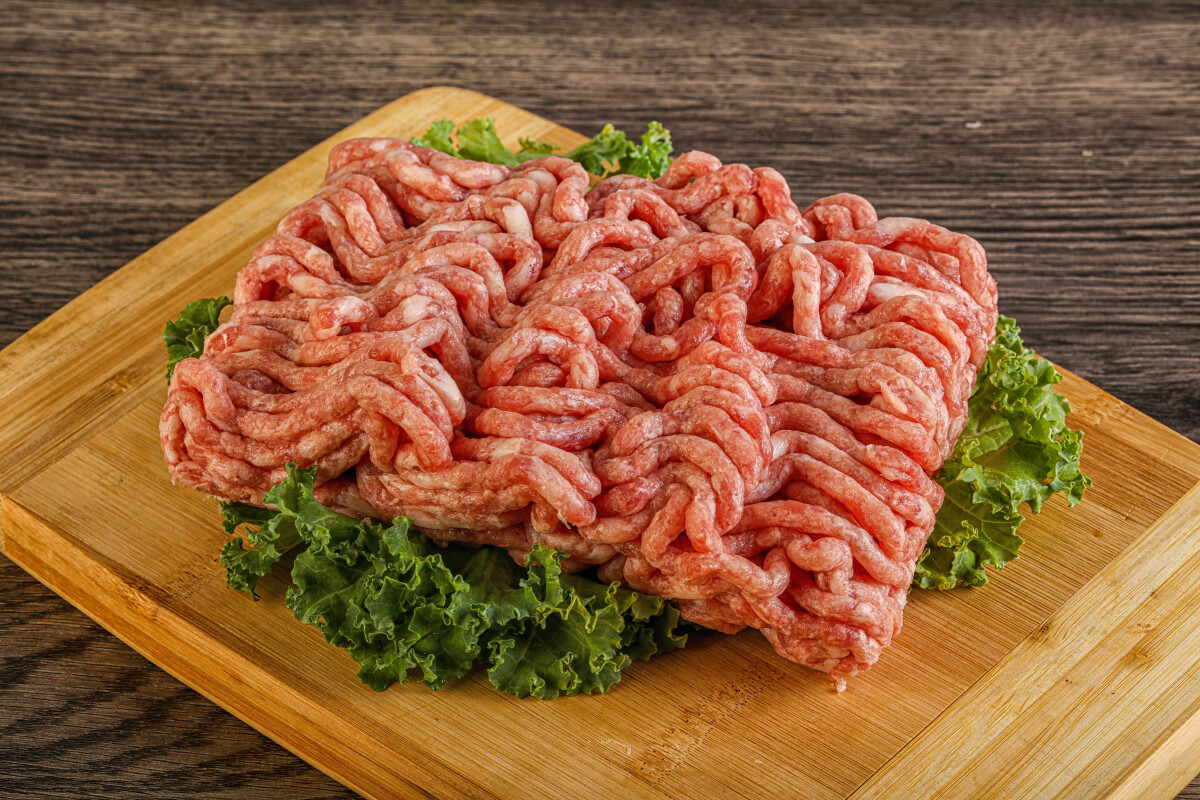 Raw pork minced meat over board