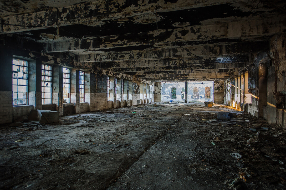 Burnt ruined industrial building. Consequences of war or fire concept