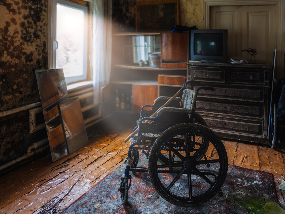 Empty wheelchair in old abandoned house