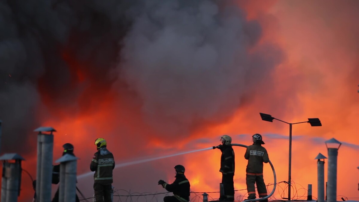 Firefighters extinguish burning industrial building in the city