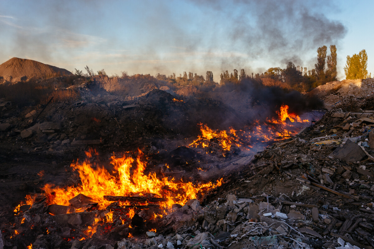 Burning garbage at landfill. Air pollution concept