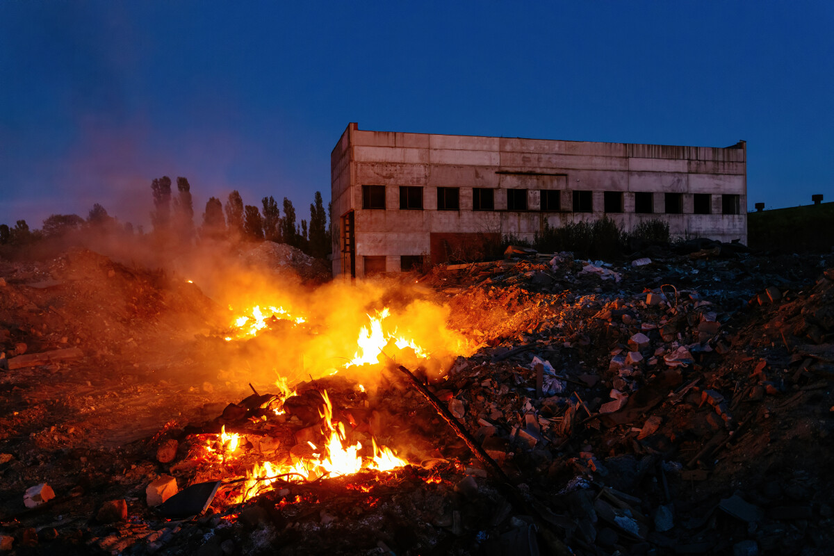 Burning building ruins at night