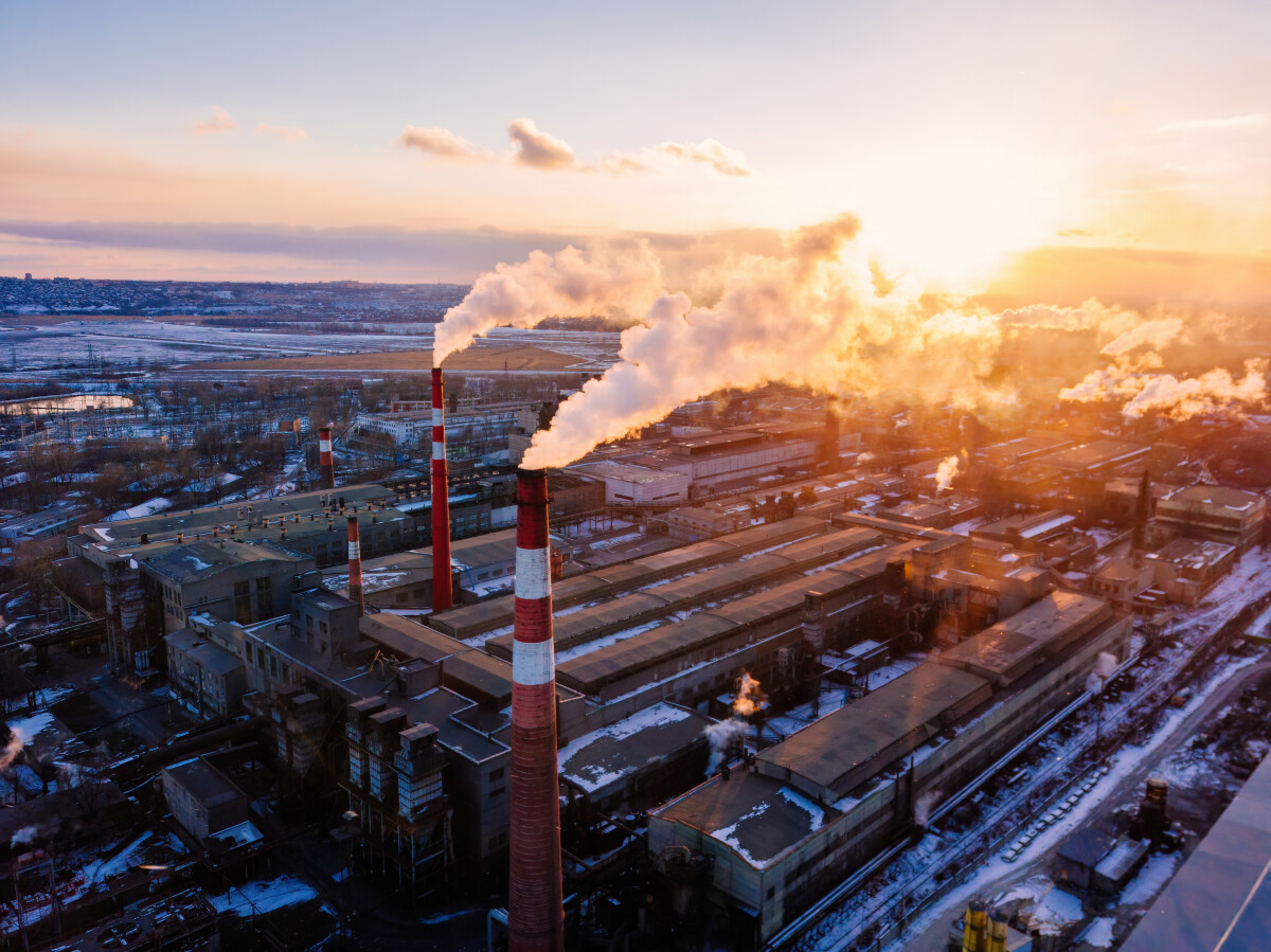 Industrial landscape at the sunset, aerial view. Smoke coming out from factory chimneys