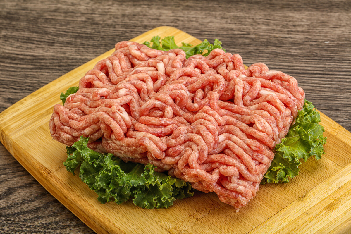 Raw pork minced meat over board