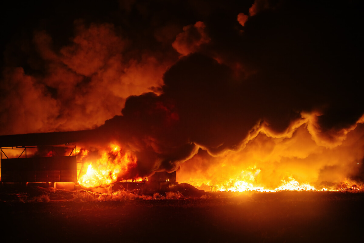 Burning industrial building. Big blaze at night