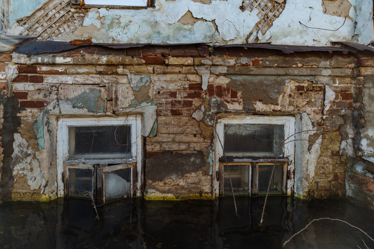 Flooded old house. Flooded old window. Natural disaster concept