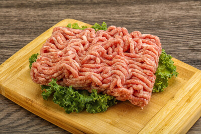 Raw pork minced meat over board for cooking